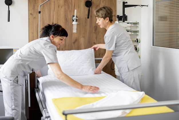 Maids make the bed in medical ward