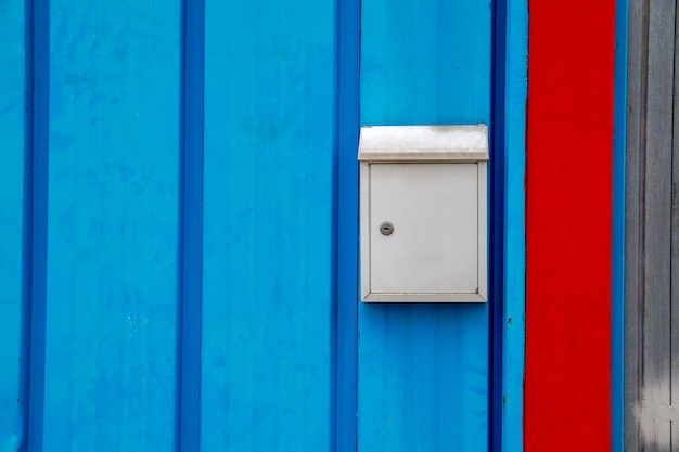 Mailbox on the blue door of the house in the city