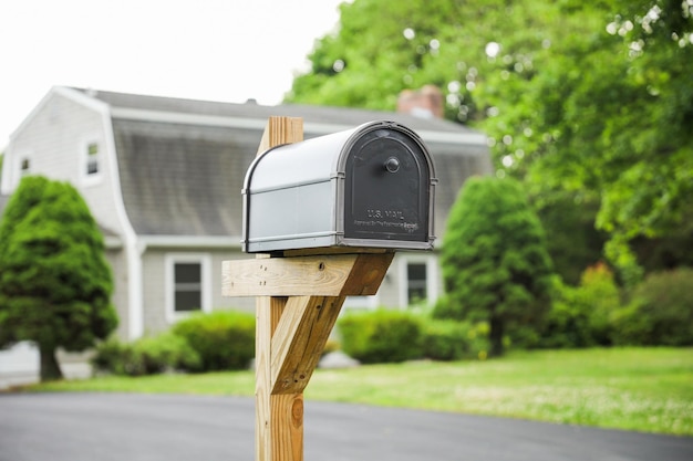 Photo mailbox stands tall against a backdrop of greenery symbolizing communication connection and the e