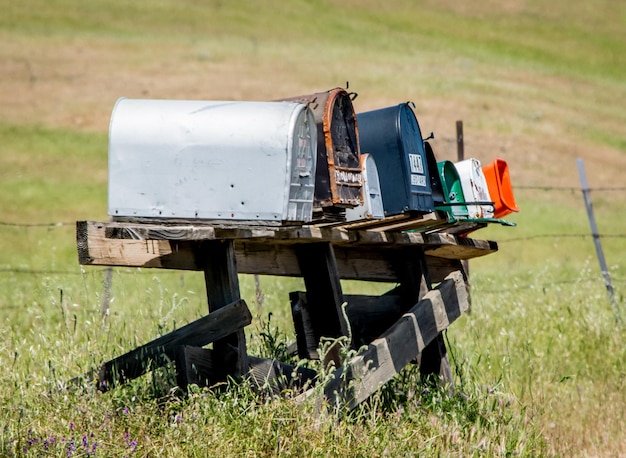 Photo mailboxes on wooden table at field