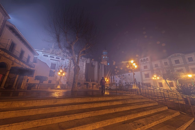 Main square under the fog in the city baza in granada