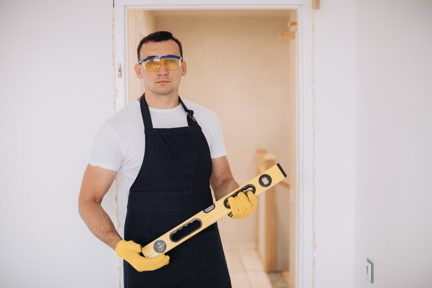 Maintenance man fixing doors with instruments