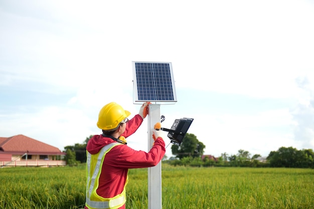 Maintenance technician during installation of solar photovoltaic panels in farmland