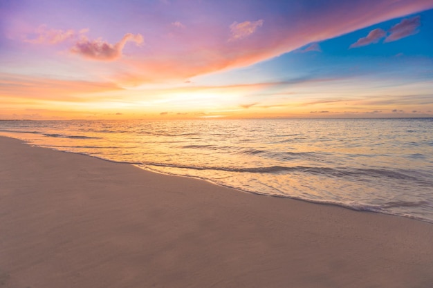 Majestic closeup view of calm sea water waves with orange sunrise sunset sunlight. Tropical island