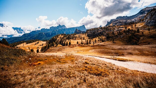 Majestic landscape of Alpine red autumn Cinque Torri Passo Falzarego Tofana Wonderful hiking nature scenery in dolomite italy near Cortina d'Ampezzo