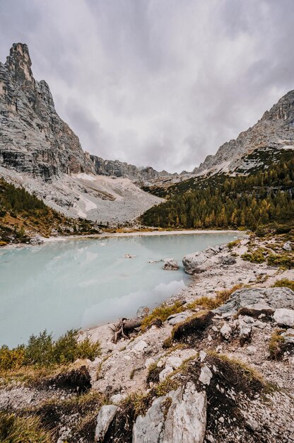 Majestic landscape of Dolomites lake Sorapis with colorful larches and high mountains Wonderful hiking nature scenery in dolomite italy near Cortina d'Ampezzo