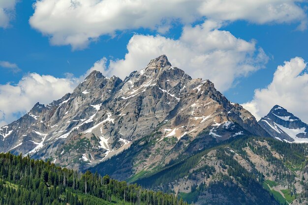 Majestic Mountain Range With Trees and Clouds in Background