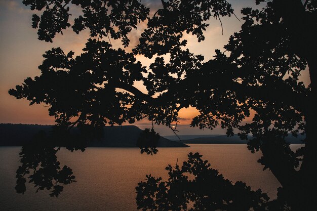 Majestic sunset in the mountains landscape over a calm lake.