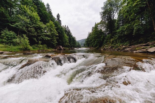 Majestic view of a mountain river in a mountain landscape Dramatic sky Carpathians