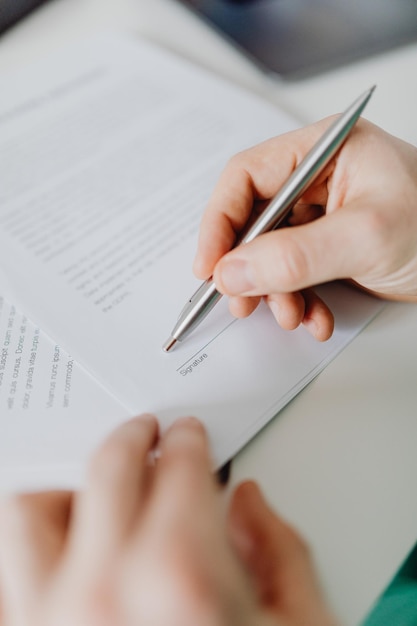 Make a deal. Close up of male hands signing business contract. Concept of female business, online