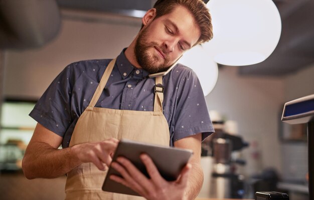 Make sure your online presence is all it can be Shot of a young man using a digital tablet while working in a coffee shop