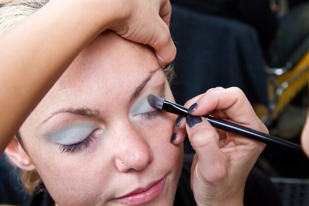 Make-up artist  applying eyebrow make-up