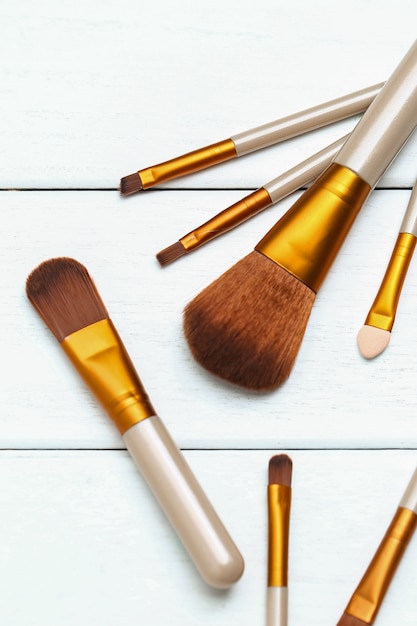 Make up brushes on wooden white desk