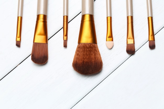 Make up brushes on wooden white desk