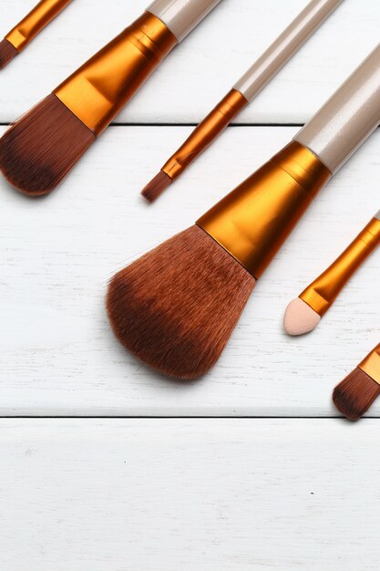 Make up brushes on wooden white desk