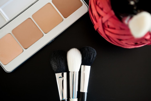 Make up and cosmetics products on black background. Professional Cosmetics