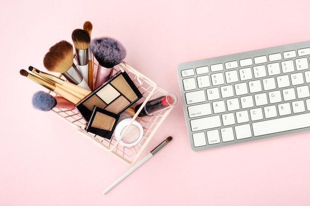 Make-up en schoonheidsproducten in het winkelmandje met toetsenbord
