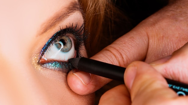 Make up eyes closeup of eye applying eyeligner vadage makeup