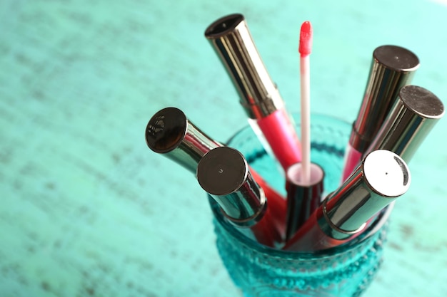 Make up lipsticks on wooden table closeup