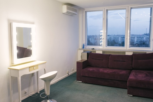 Make-up mirror and purple sofa in the photo studio