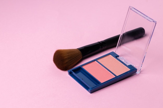 Make up palette with brush on pink