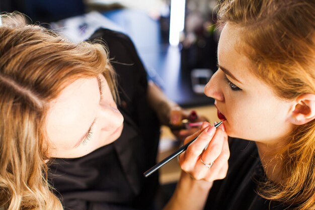 Make up in process, red lips