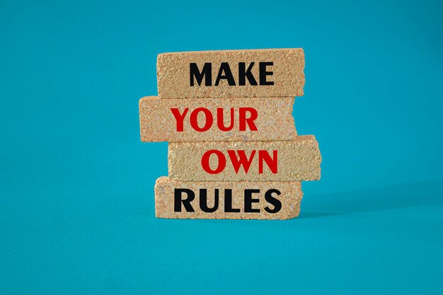 Photo make your own rules symbol concept red words make your own rules on brick blocks