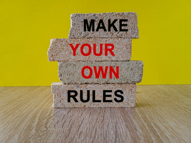 Photo make your own rules symbol concept words make your own rules on brick blocks beautiful wooden table