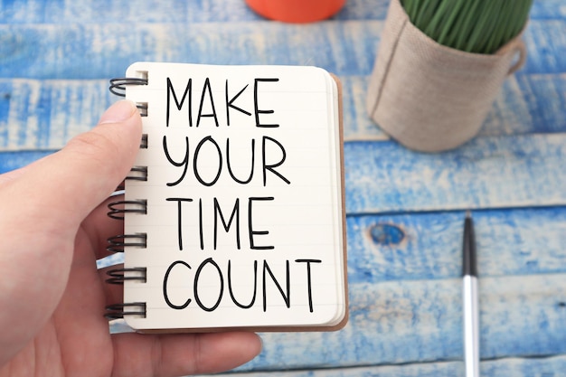 Photo make your time count text words typography written on book against wooden background