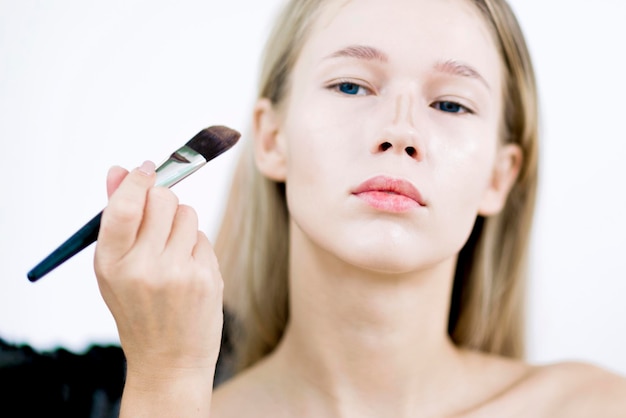 Makeup artist applies corrector Makeup in the studio