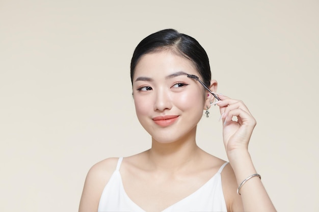 Makeup artist combs eyebrows in a beauty salon