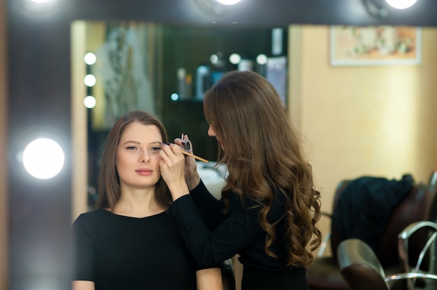 Makeup artist makes beautiful girl makeover