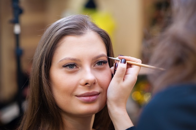 Makeup artist makes beautiful girl makeover