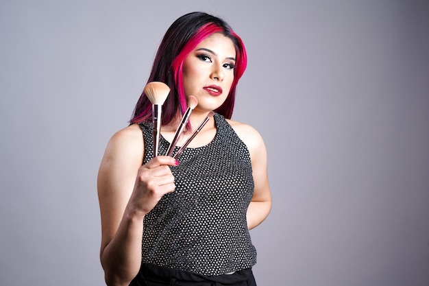 Makeup artist woman holding brushes on white background