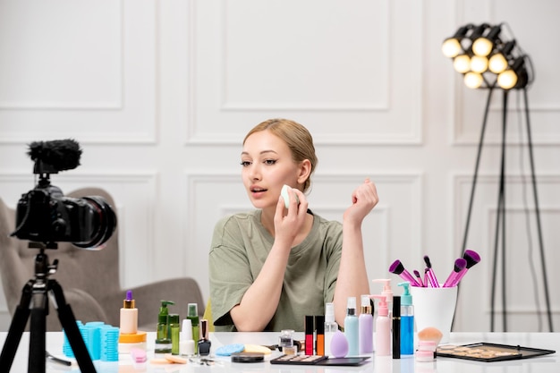 Makeup blogger recording makeup tutorial on camera young cute pretty girl taking care of herself