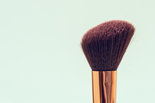 Makeup brush on green background