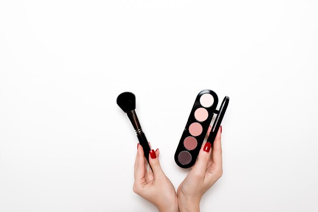 Makeup brush in hand isolated on the white 