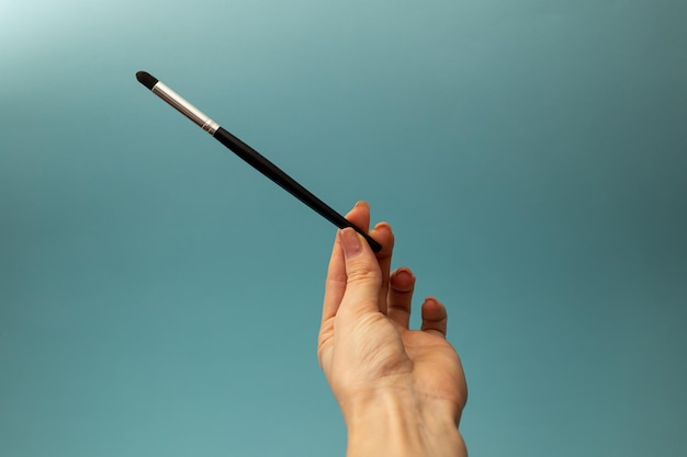 Makeup brushes on a blue background