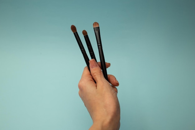 Makeup brushes on a blue background