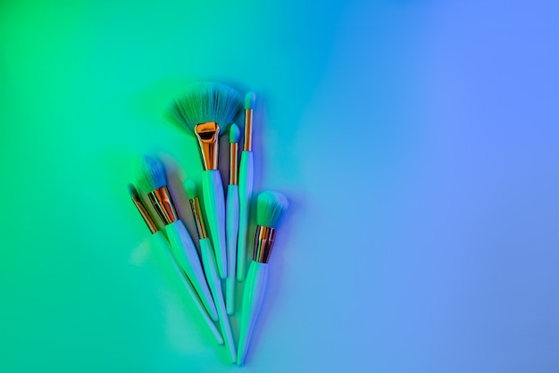 Makeup brushes on bright neon.