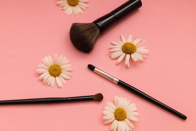 Makeup brushes on a pink backgroundxA