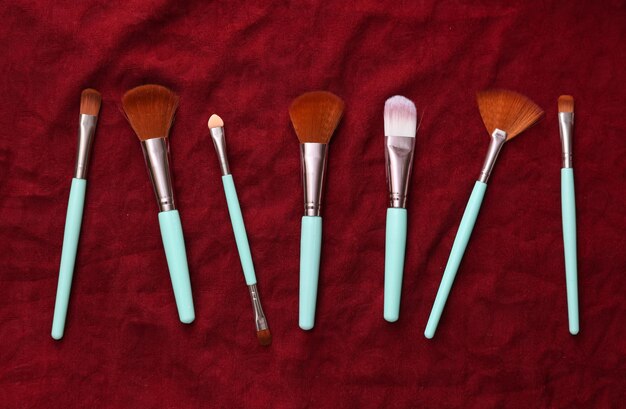 Makeup brushes on red silk background Beauty still life