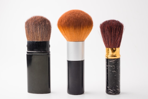 Makeup brushes on a white background.