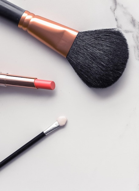 Makeup and cosmetics flatlay on marble