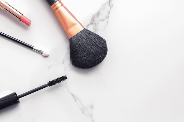 Makeup and cosmetics flatlay on marble