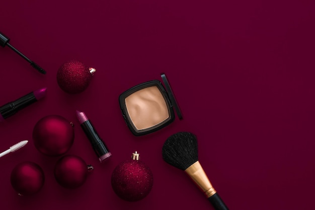 Makeup and cosmetics product set for beauty brand Christmas sale promotion luxury burgundy flatlay background as holiday design