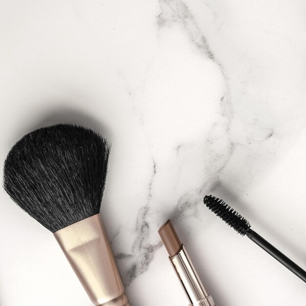 Makeup and cosmetics products on marble flatlay background