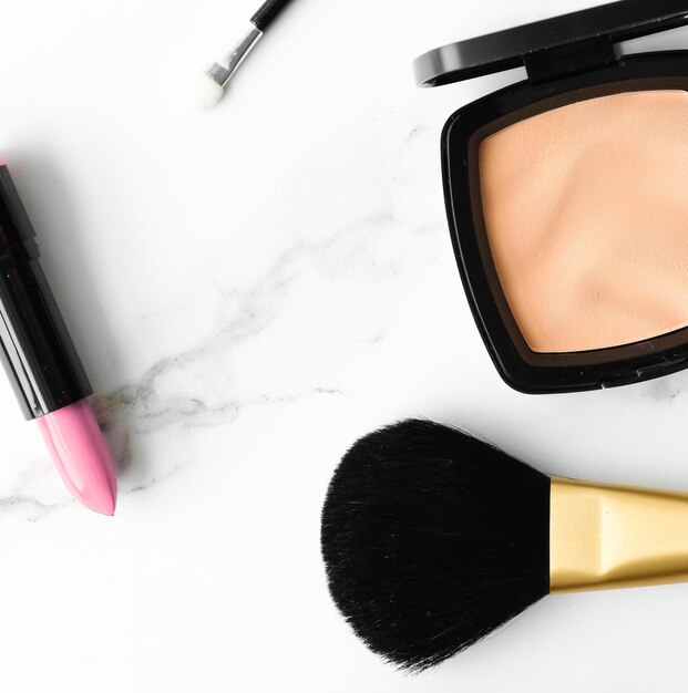 Makeup and cosmetics products on marble flatlay background