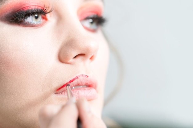 Makeup lips Applying a bright red lipstick