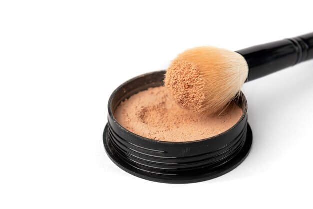 Makeup powder isolated on white wall.